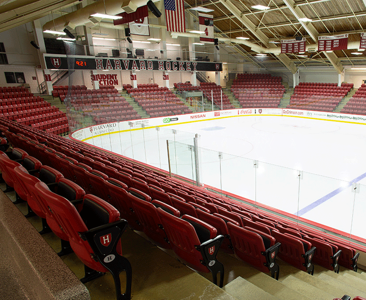 red seating, an ice rink and scoreboard in the Bright-Landry Hockey Center